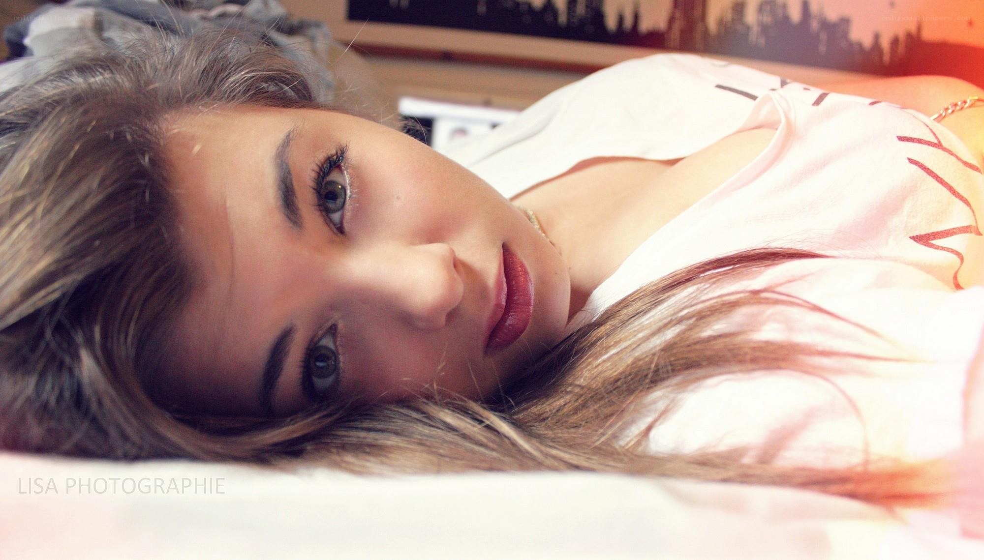 woman lying on bed looking at camera