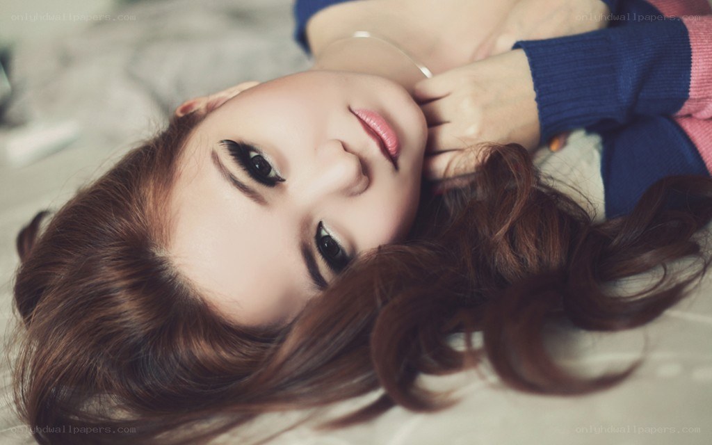 woman lying on bed looking at camera