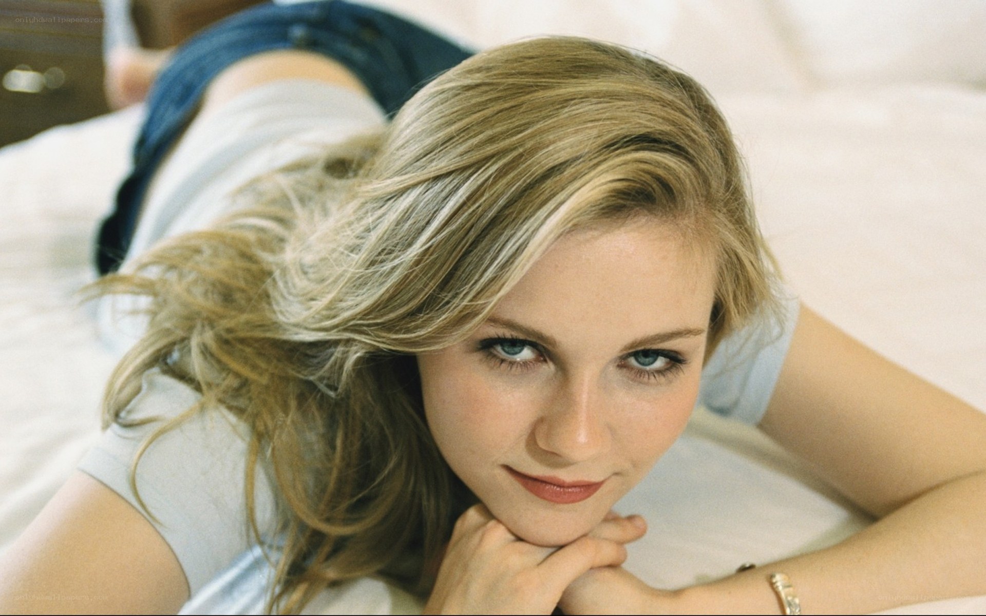 woman lying on bed looking at camera