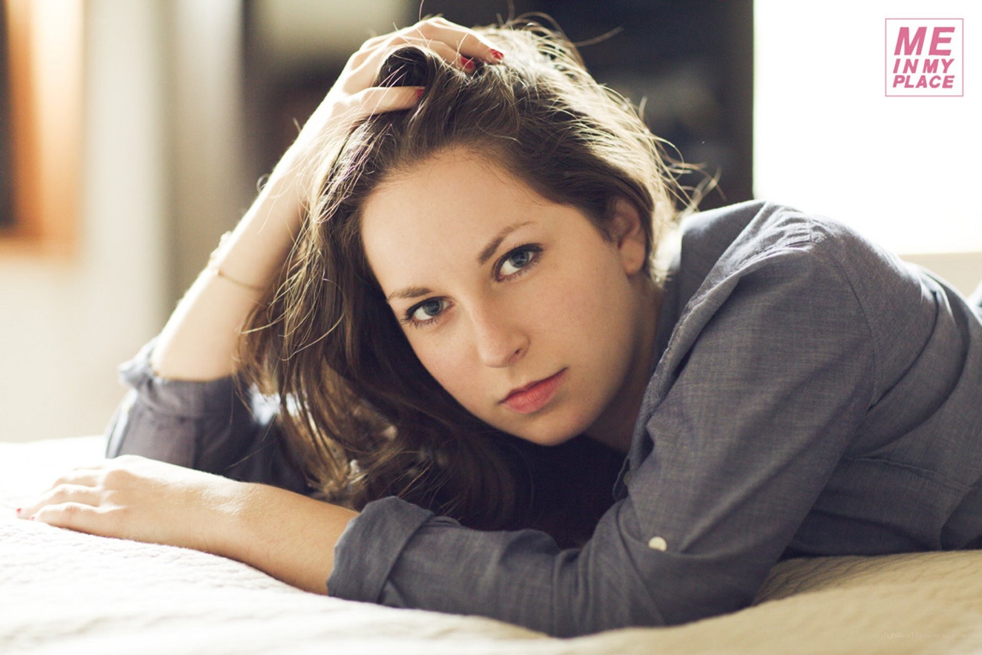 woman lying on bed looking at camera