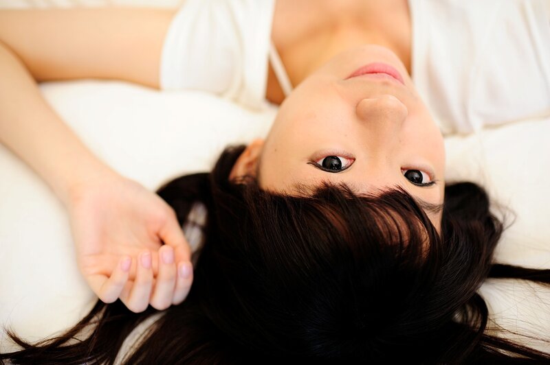 woman lying on bed looking up