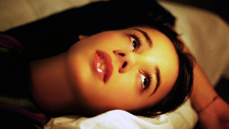 woman lying on bed looking up