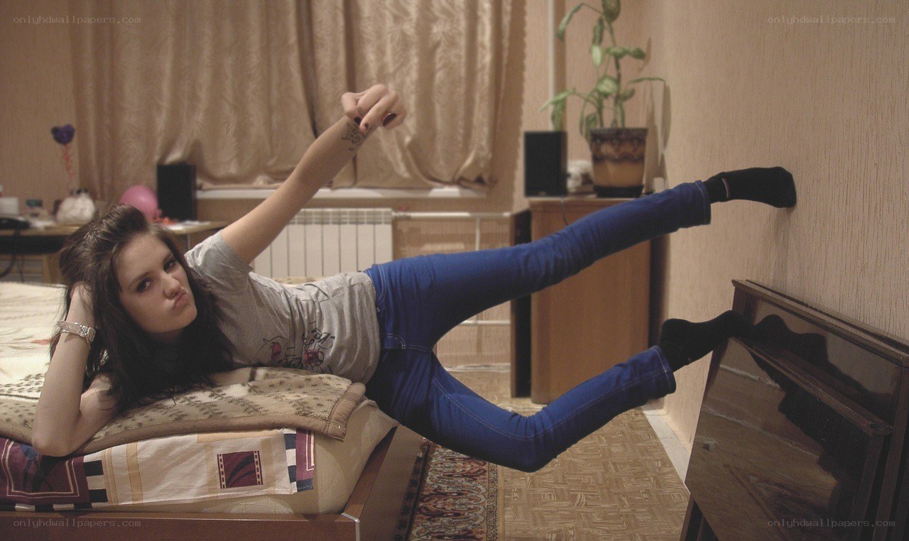 woman lying on bed playfully