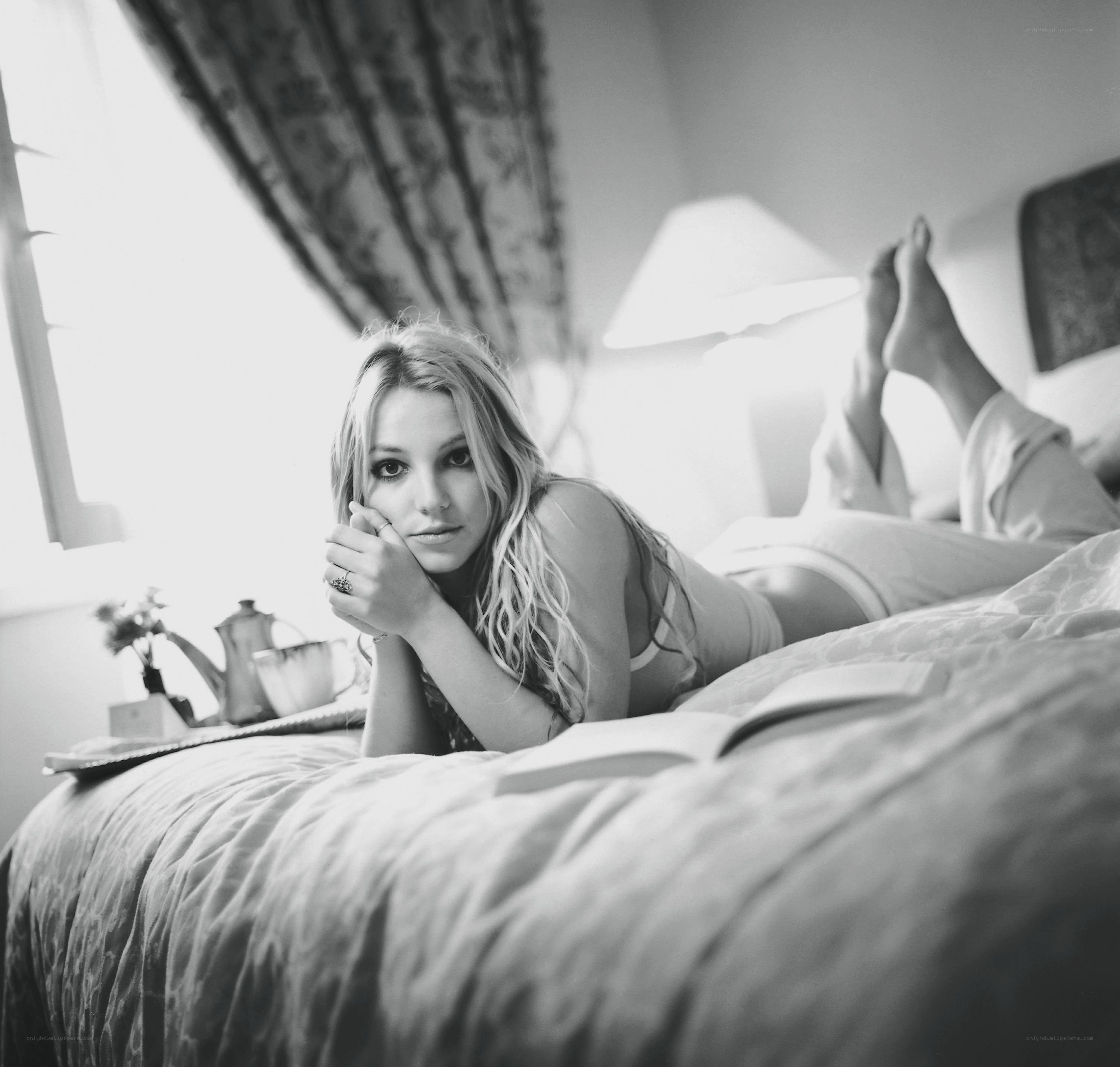 woman lying on bed reading