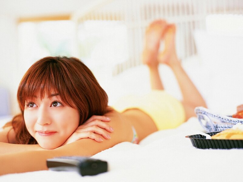woman lying on bed smiling