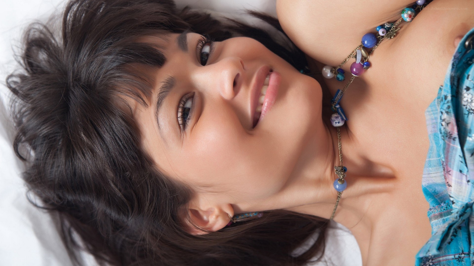 woman lying on bed smiling