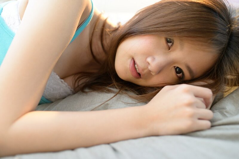 woman lying on bed smiling