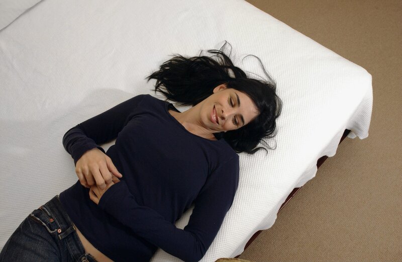 woman lying on bed smiling