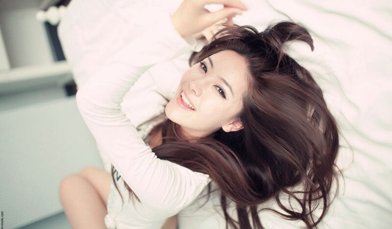 woman lying on bed smiling