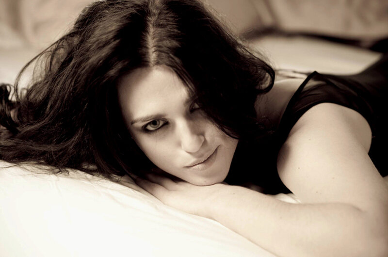 Woman Lying on Bed — White, Intimate, Photograph, Pillow, Black Top, Black