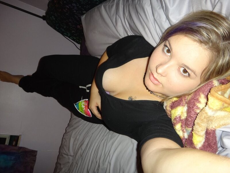 woman lying on bed with colorful blanket