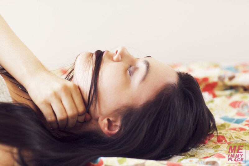 woman lying on bed with eyes closed