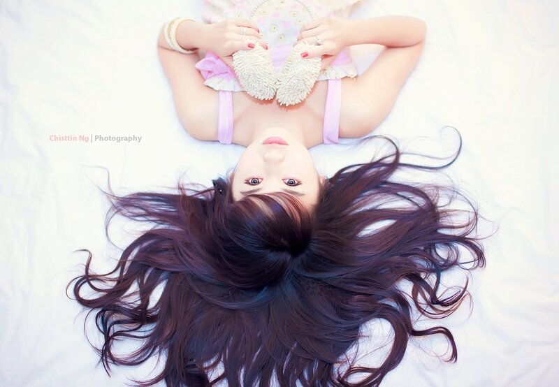woman lying on bed with long hair