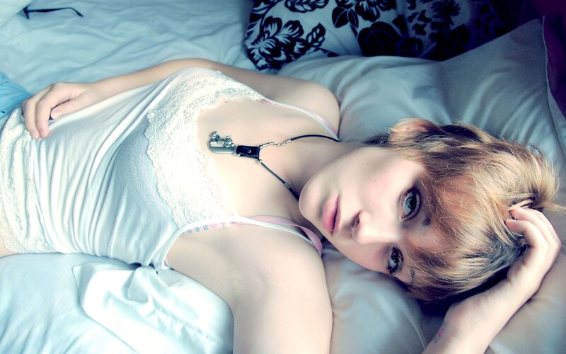 woman lying on bed with short hair