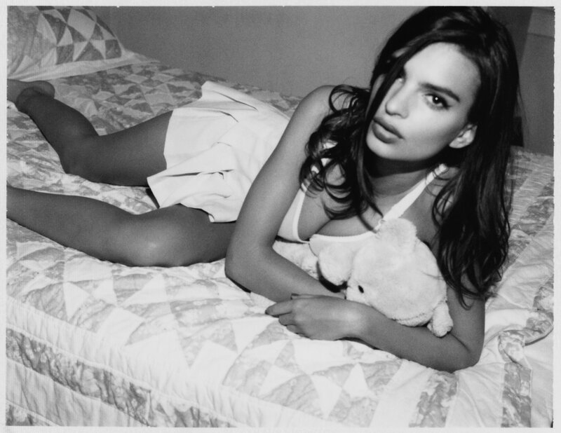 woman lying on bed with teddy bear