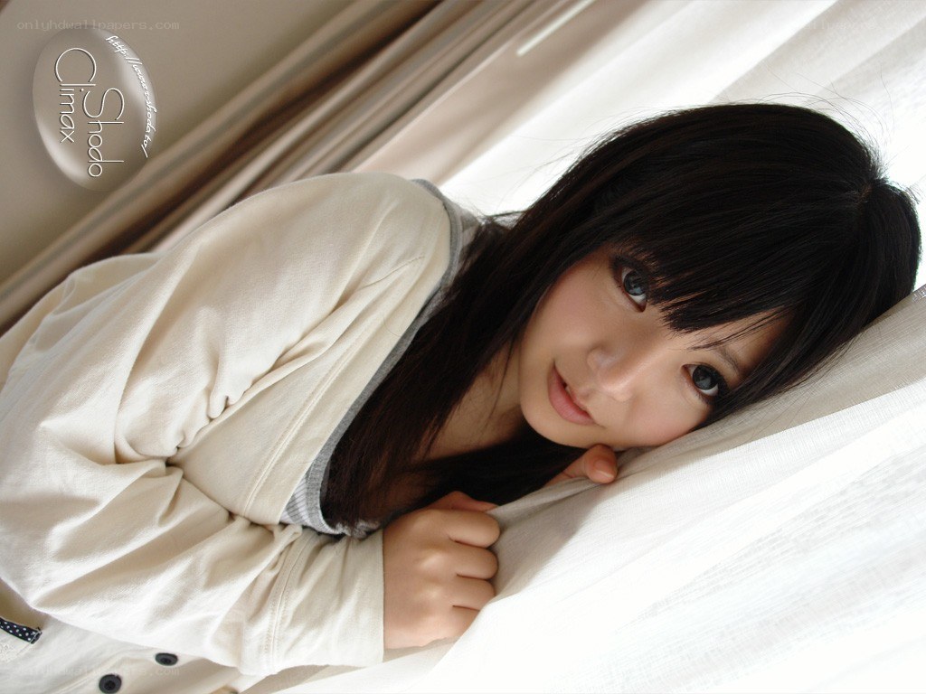 woman lying on bed with white sheets