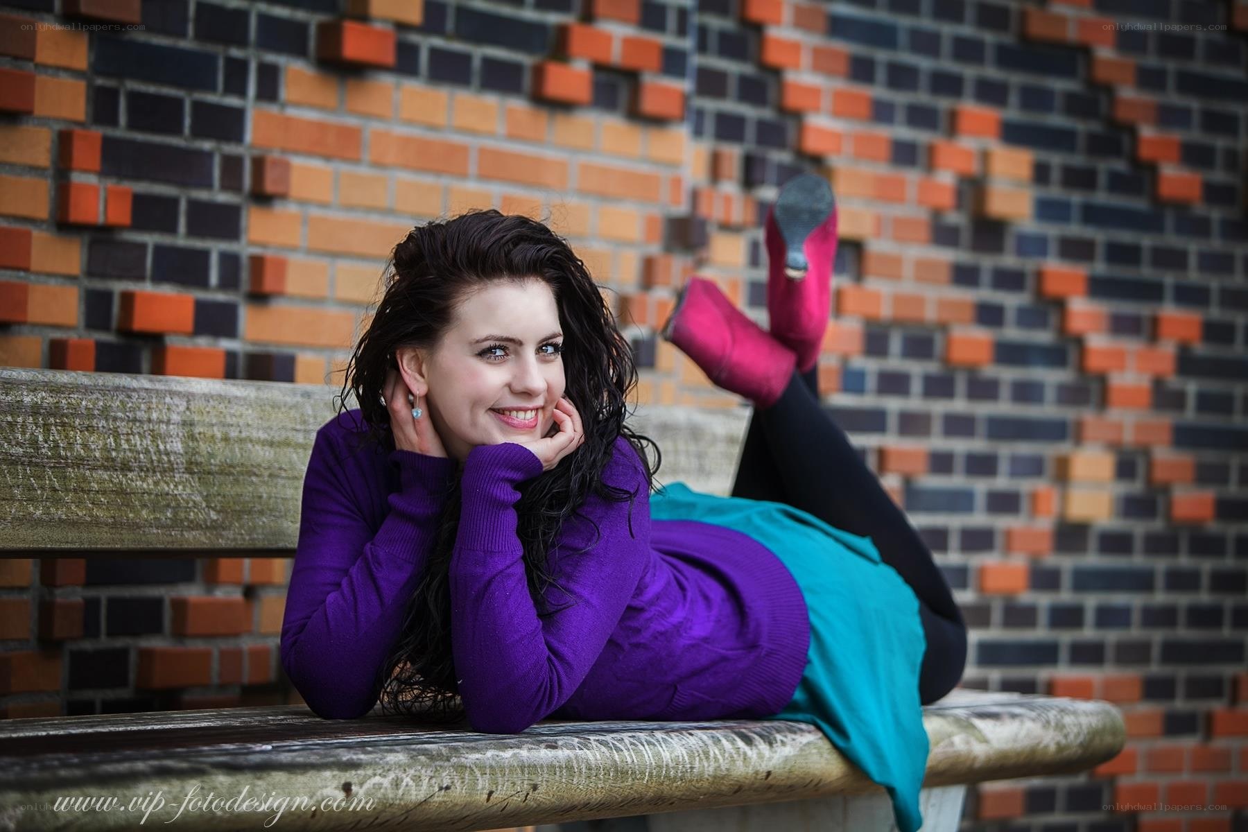 woman lying on bench