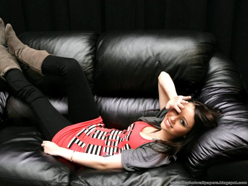 woman lying on black couch