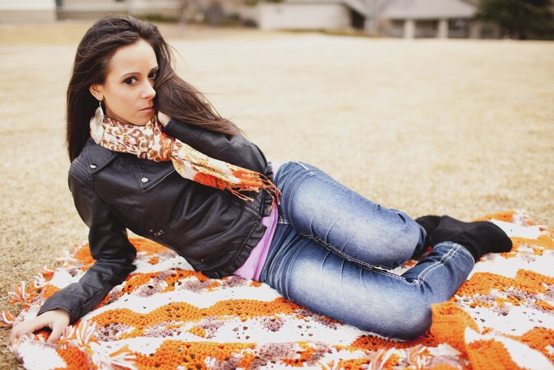 woman lying on blanket outdoors