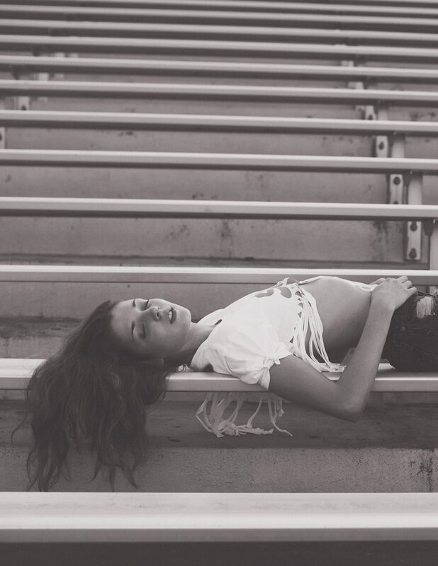 woman lying on bleachers