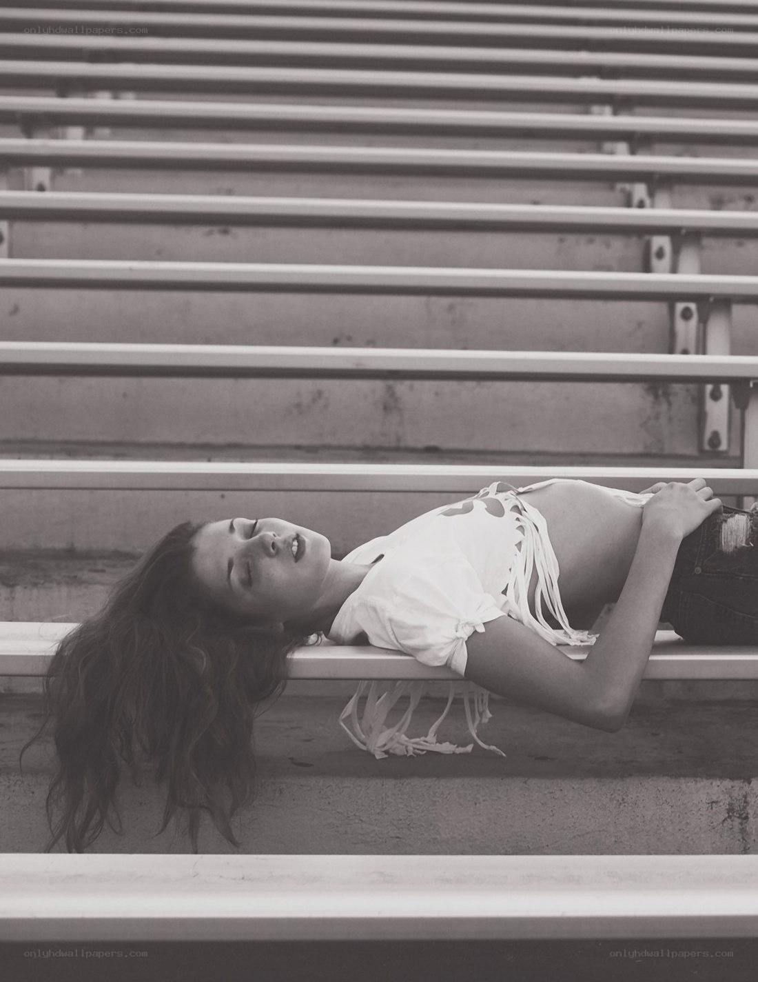 woman lying on bleachers