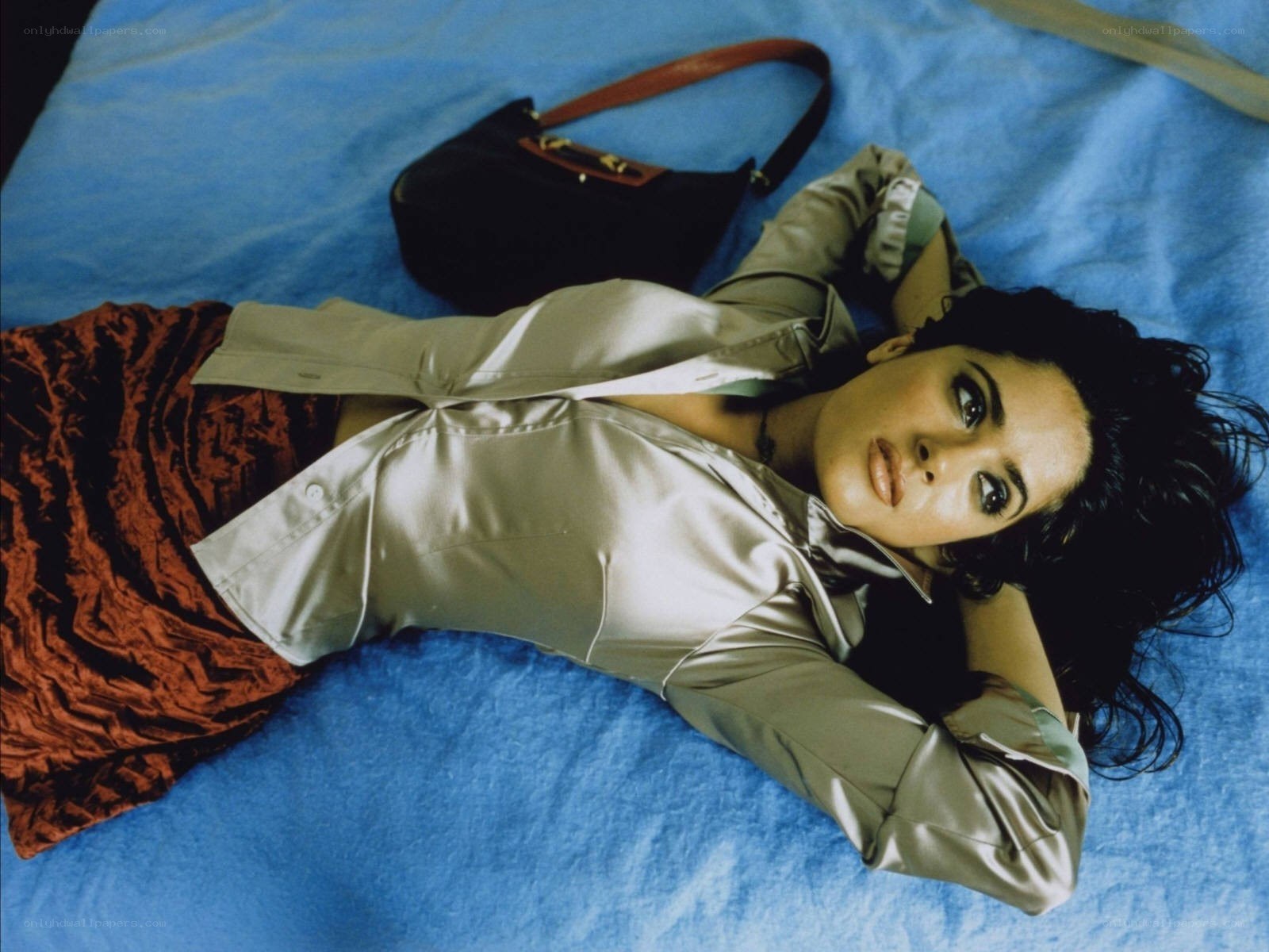 woman lying on blue bed