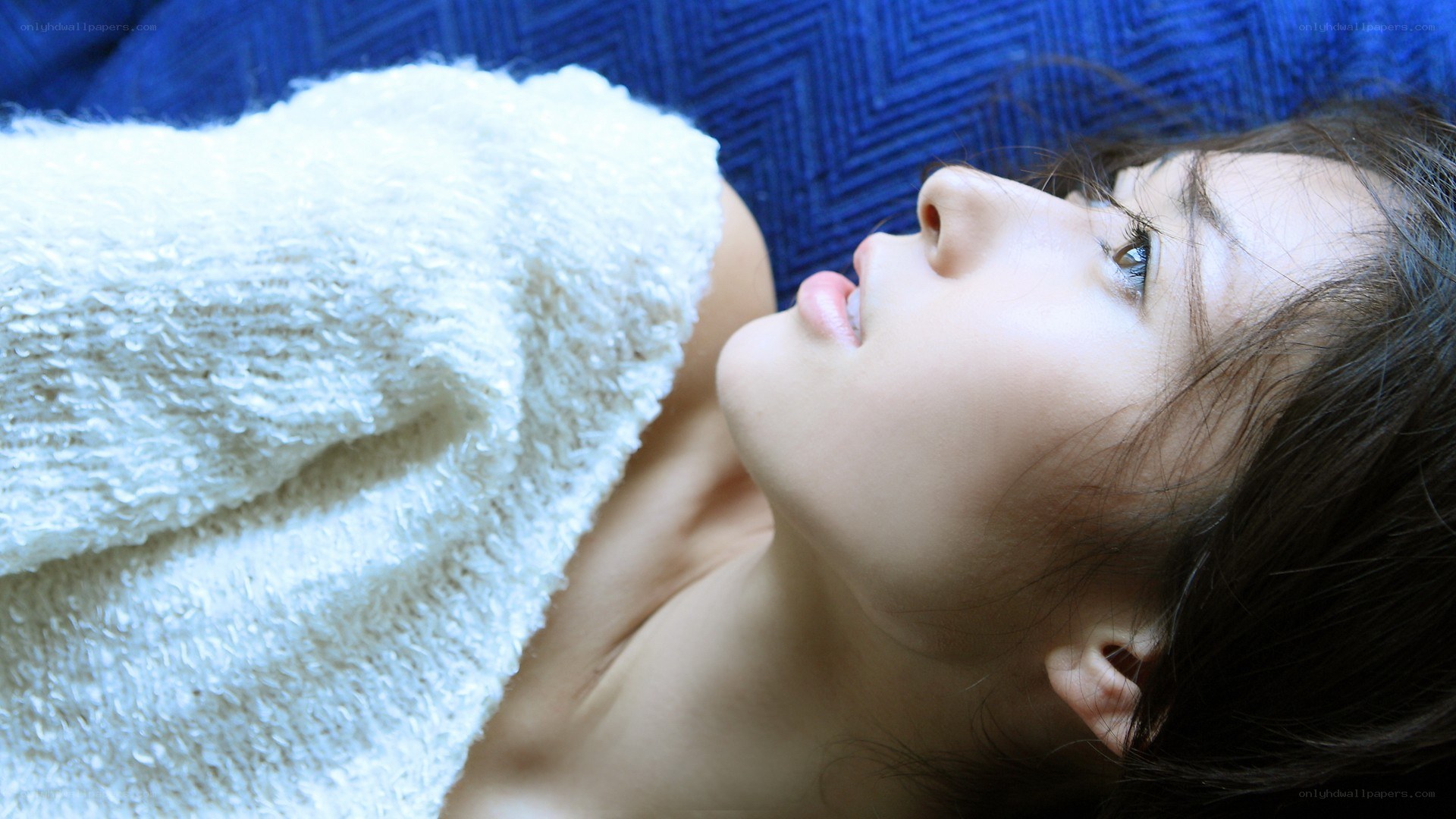 woman lying on blue couch