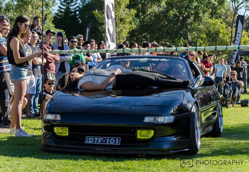 Woman lying on car hood at event