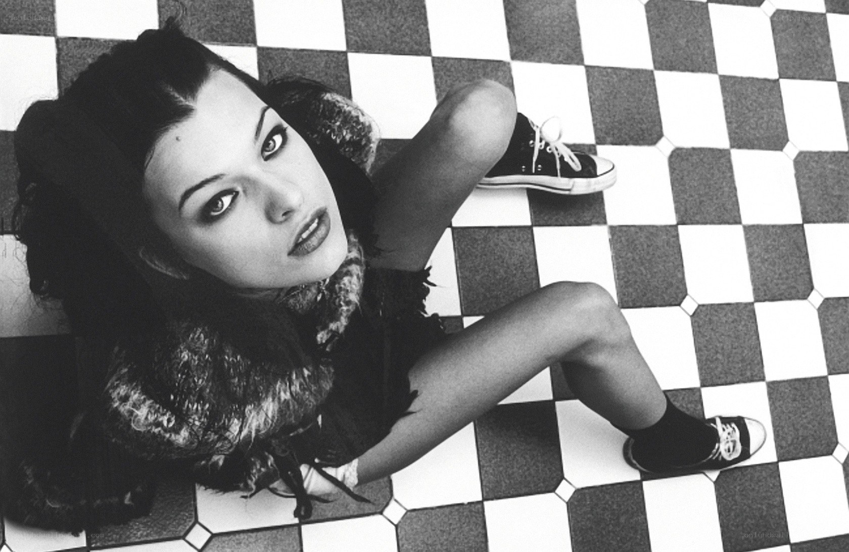 woman lying on checkered floor