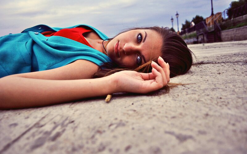 woman lying on concrete