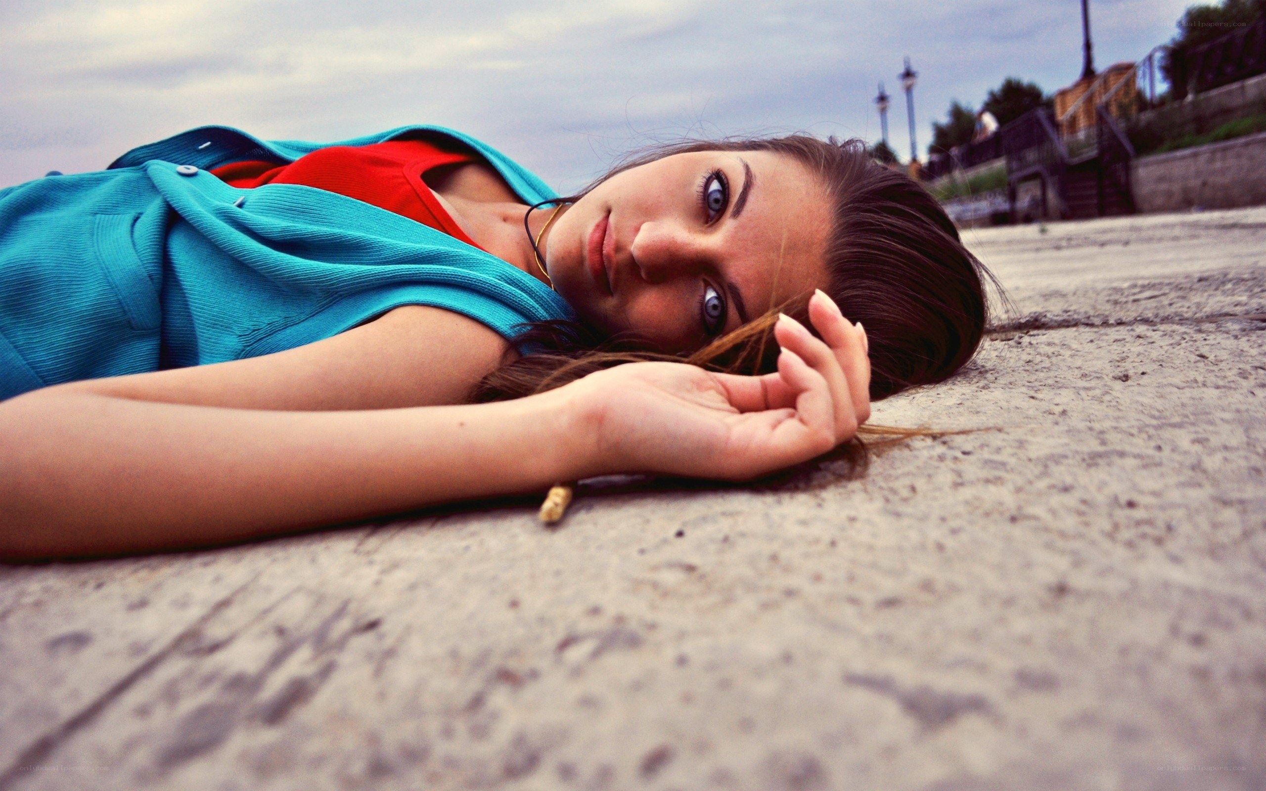woman lying on concrete