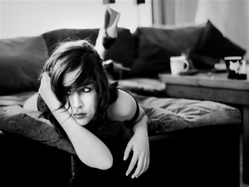 Woman Lying on Couch — Black, Contemplative, Photograph