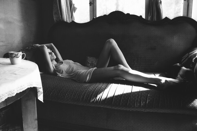 Woman Lying on Couch — Black, Relaxed, Morning