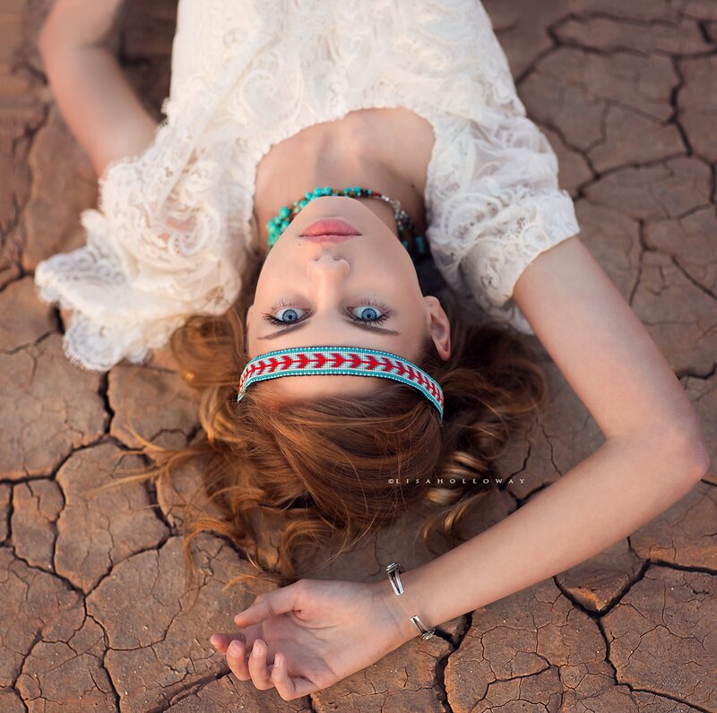 Woman Lying on Cracked Earth