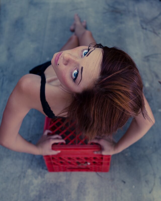 woman lying on crate looking up