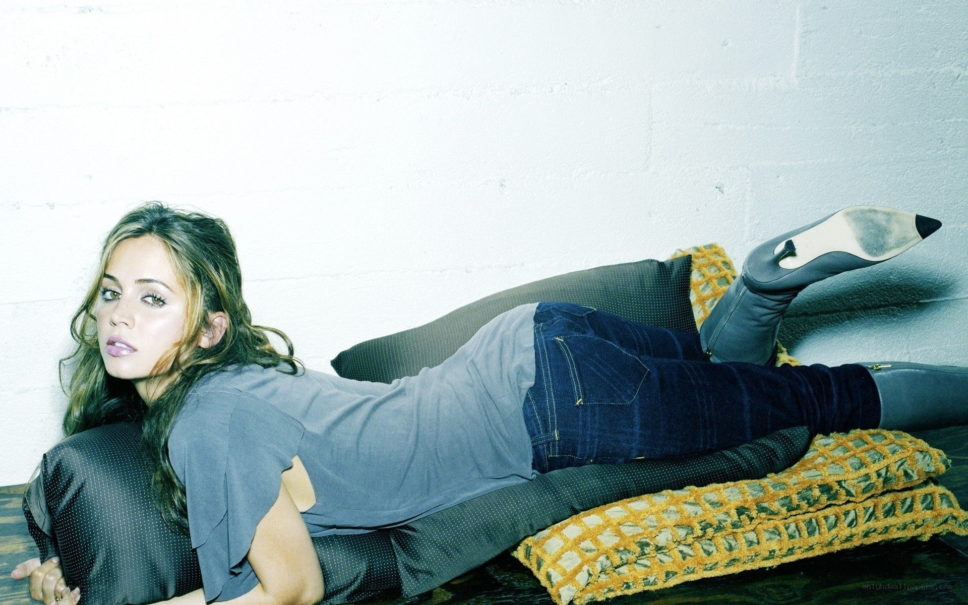 woman lying on cushions