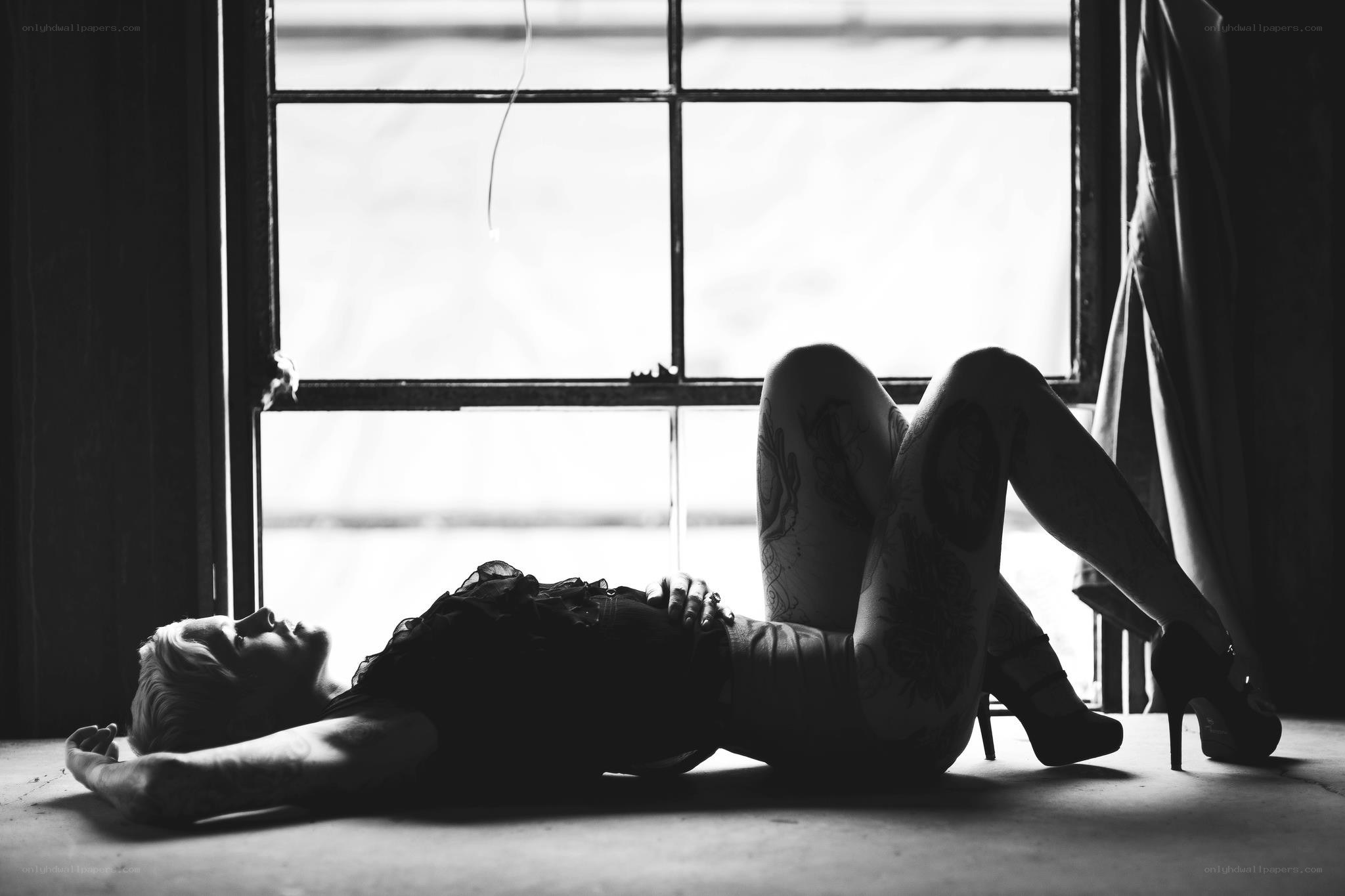 woman lying on floor by window
