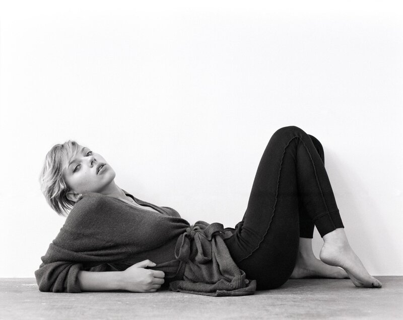 woman lying on floor in black and white