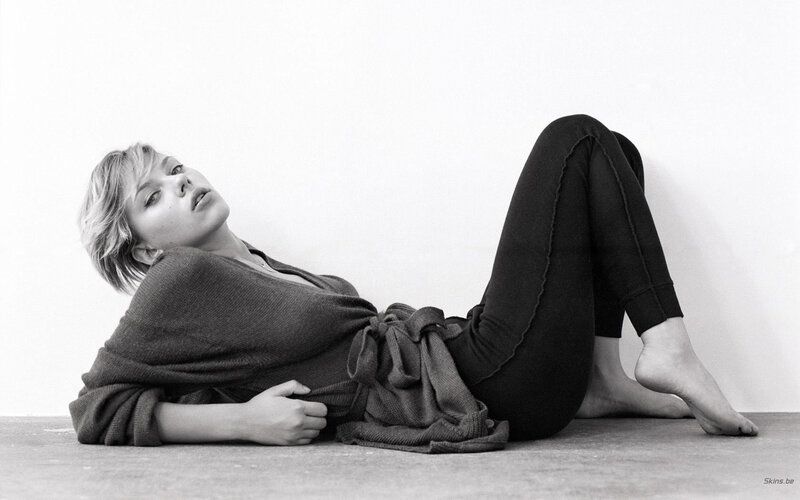woman lying on floor in black and white