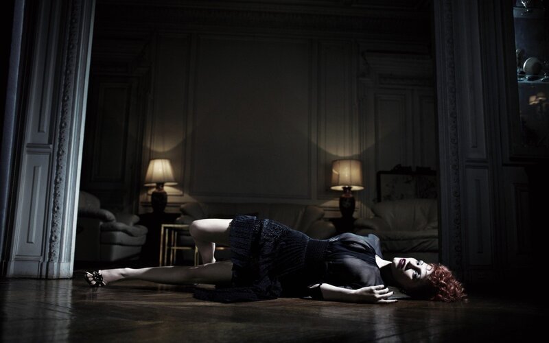 woman lying on floor in dark room