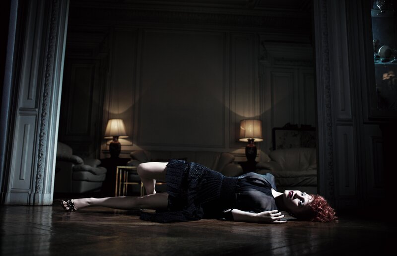 woman lying on floor in dark room