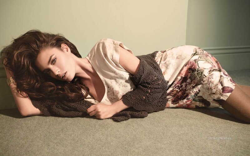 woman lying on floor in floral dress
