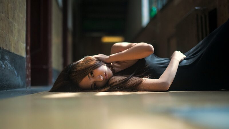 woman lying on floor in hallway