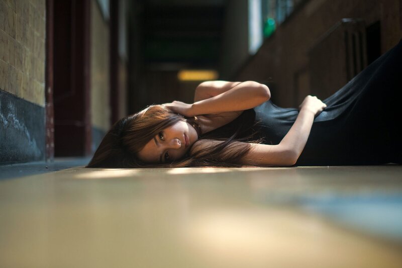 woman lying on floor in hallway