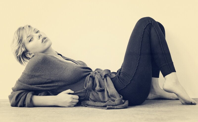 woman lying on floor in sweater