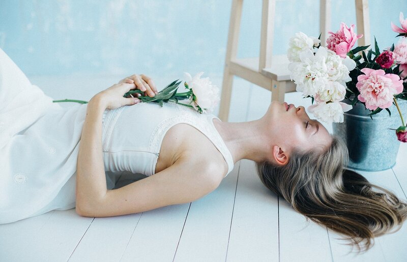 Woman Lying on Floor — White, Serene, Photograph, Flowers