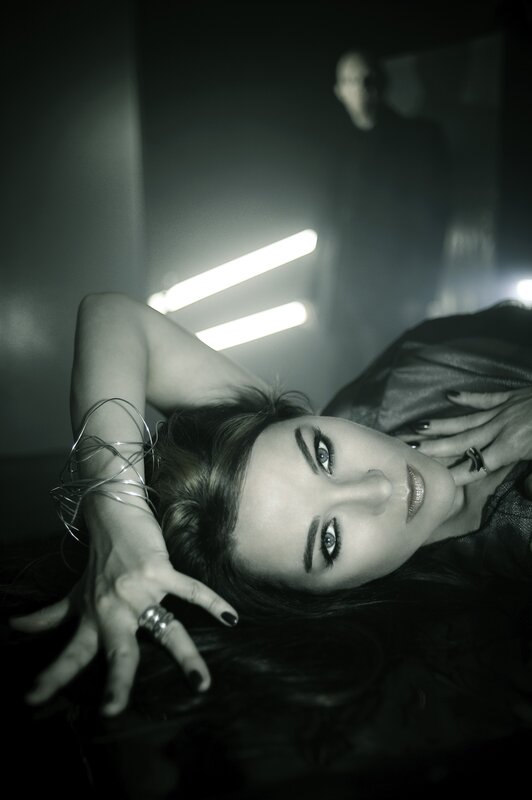 woman lying on floor with man in background