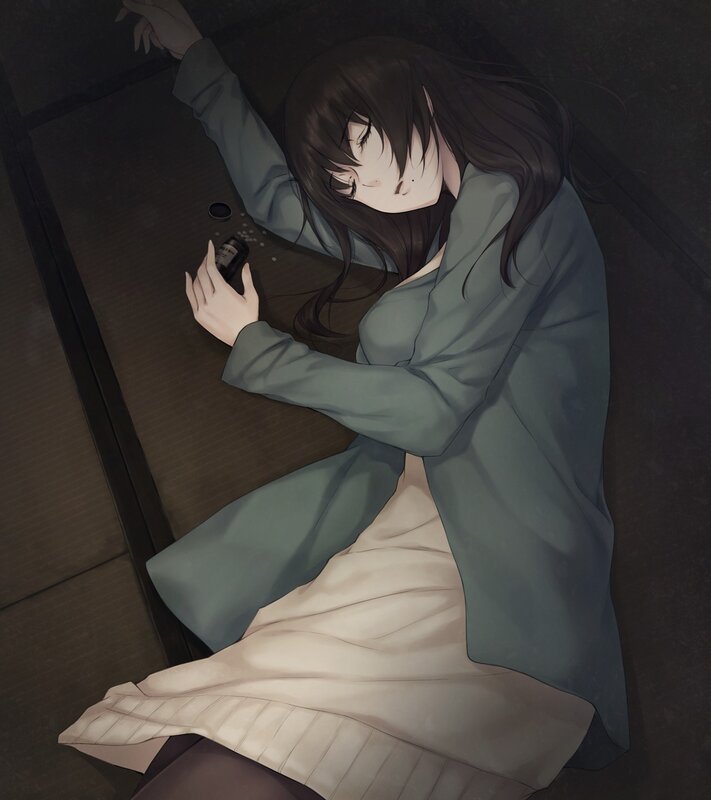 Woman lying on floor with pills