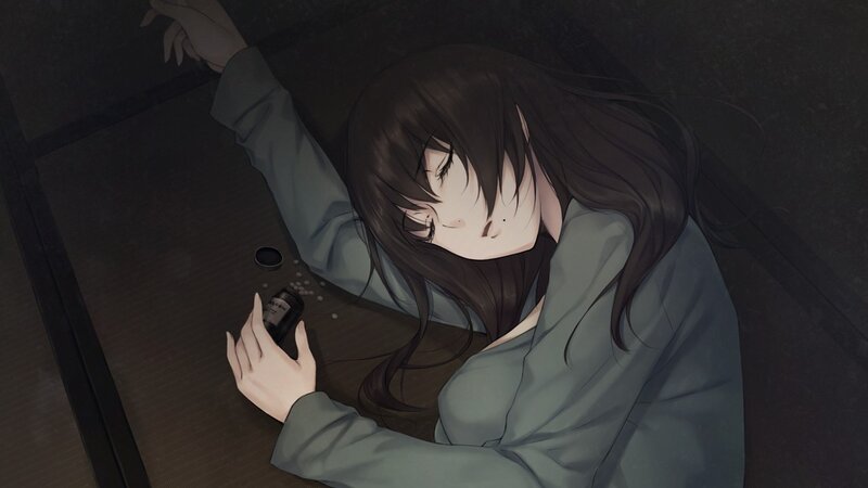 woman lying on floor with pills