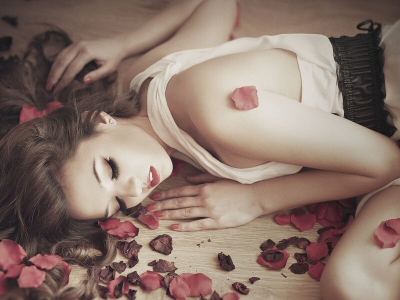 woman lying on floor with rose petals